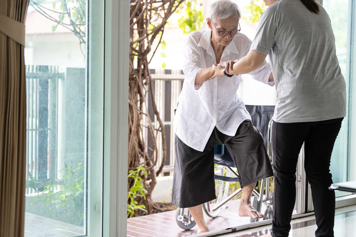 senior getting help to prevent falls