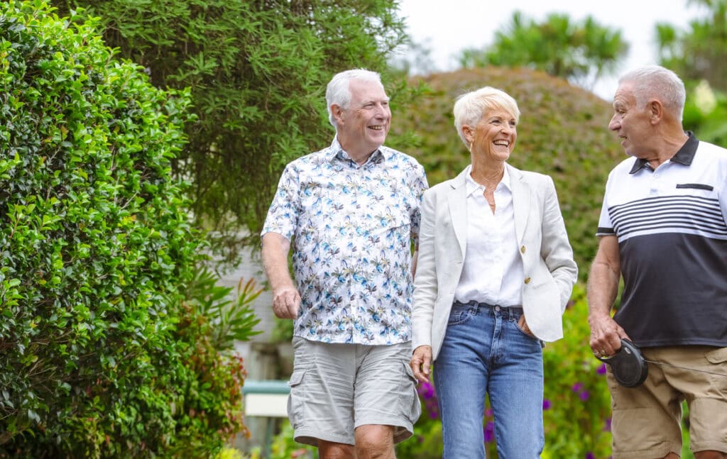 three retirement village residents chatting on a walk