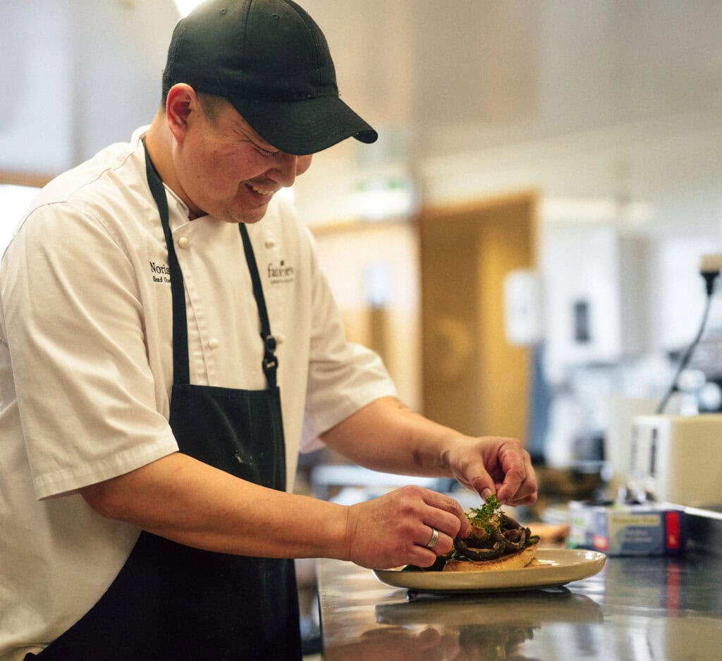 chef adding finishing touches to dinner